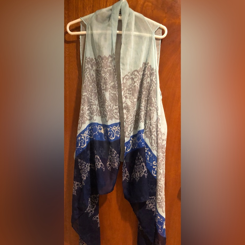 Beach cover up , vest , top . Shades of blue